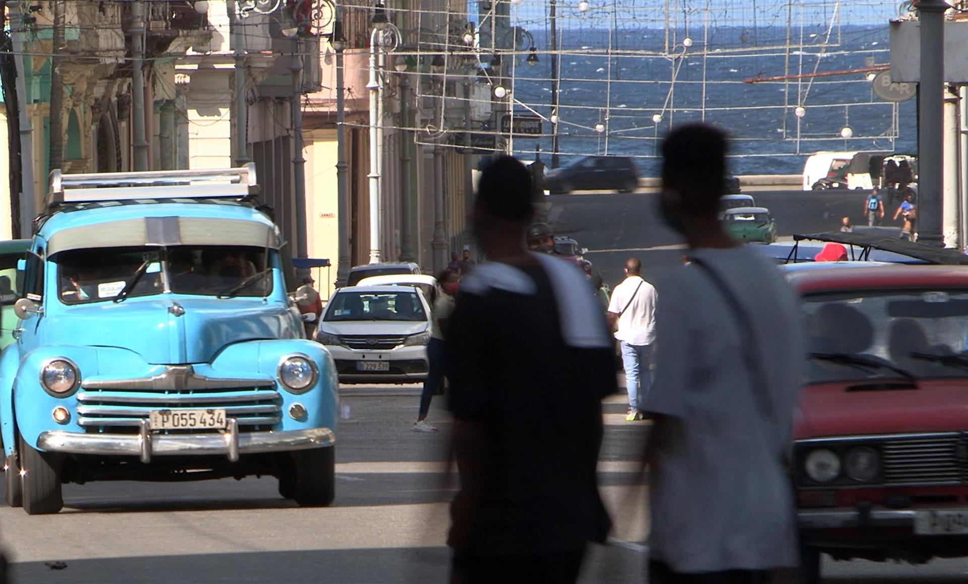 Imagen de archivo que muestra a dos personas paseando frente a un automóvil clásico en La Habana (Cuba). EFE/ Felipe Borrego

