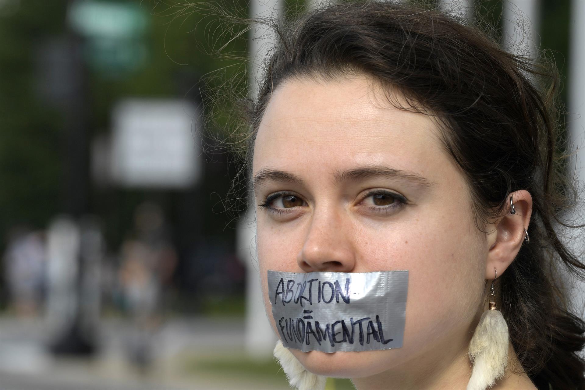Imagen de archivo que muestra a una mujer con una cinta en la boca que dice 