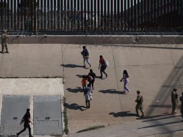 Miembros de la Guardia Nacional de Texas reciben a un grupo de migrantes, en la frontera de en Ciudad Juárez (México). Imagen de archivo. EFE/Luis Torres
