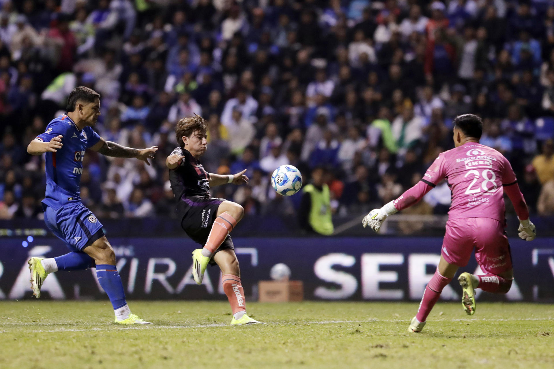 Gabriel Fernández (i) de Cruz Azul disputa el balón con Iker Moreno (c) y Ricardo Gutiérrez (d) de Puebla este sábado, durante un partido de la tercera fecha del torneo Clausura mexicano jugado en el estadio Cuauhtémoc de Puebla. EFE/ Hilda Ríos
