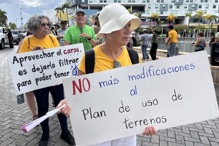 Personas sostienen carteles durante una manifestación frente al Centro de Convenciones de Puerto Rico este miércoles, en San Juan (Puerto Rico). EFE/ Esther Alaejos
