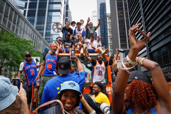 Los New York Knicks celebraron este jueves su primer título de la NBA desde 1973 con un multitudinario desfile que tiñó de naranja y azul el bajo Manhattan y convirtió Broadway en una marea humana en la que se mezclaban aficionados, música y famosos. EFE/EPA/KENA BETANCUR

